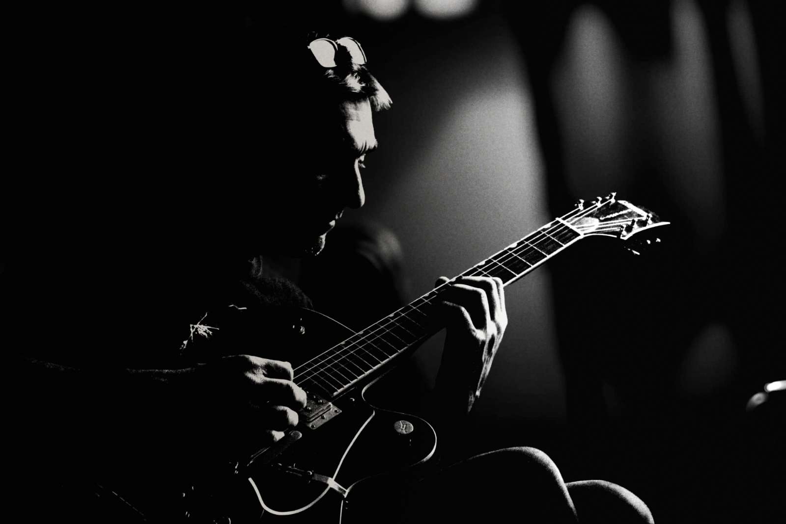 Andy McGrath playing guitar, black and white