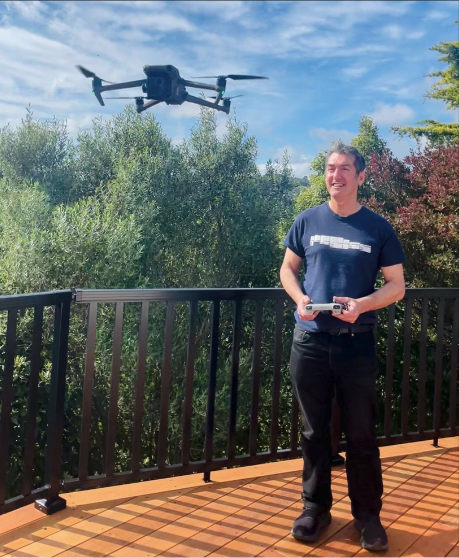 Andy McGrath flying a drone from a timber deck