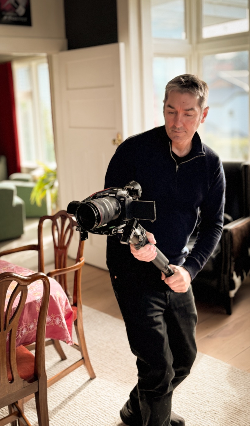 Andy McGrath filming inside a home with a gimbal-mounted camera