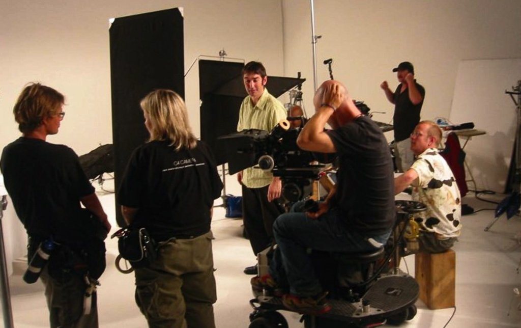 Andy McGrath directing on a studio set with a film crew