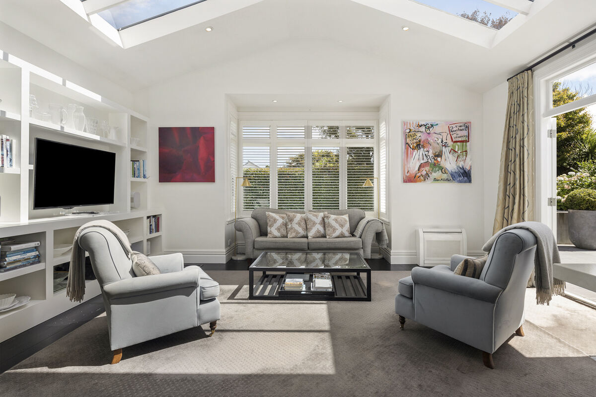 Bright living room with skylights and garden doors